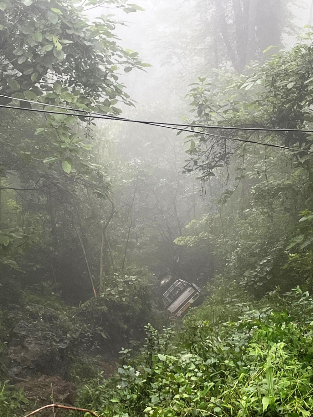 The pickup vehicle that veers off the highway near Chiephobozou town on June 25 is seen lodged on the road below. (Morung Photo)